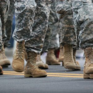 Military boots marching on pavement.